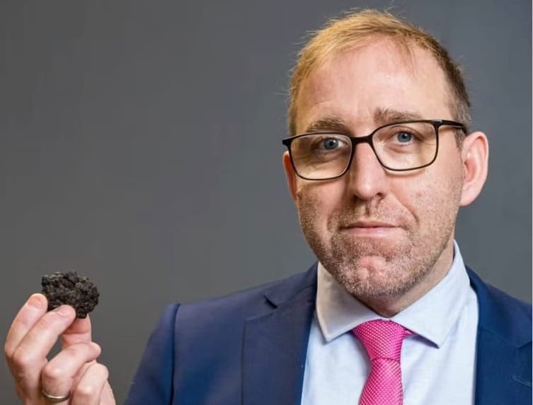Professor Andrew Sweetman holding the poly-metallic nodule he believes could be producing oxygen